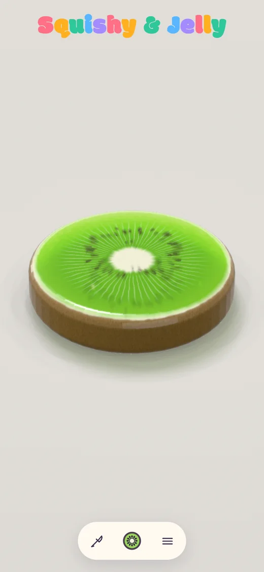 Squishy & Jelly pe telefon: o felie lucioasă de kiwi din jeleu verde, cu semințe negre și miez crem.